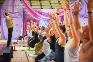 Large group practicing yoga